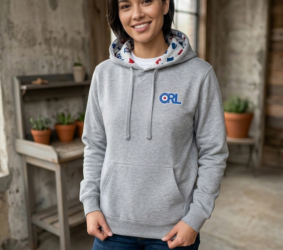 Woman wearing a grey CRL hoodie with ORL logo and a custom hood lining featuring Minnesota shapes, mittens, and curling stones.
