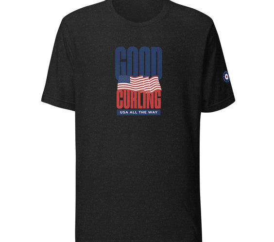 Front view of the “Good Curling USA All The Way” T-shirt in black heather, showcasing the bold red, white, and blue curling-inspired USA flag design and CRL logo sleeve detail.