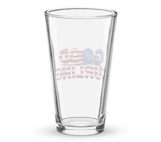 Back view of a clear shaker pint glass showing the reversed “Good Curling” USA flag print through the glass. Patriotic curling-themed drinkware by CRL.