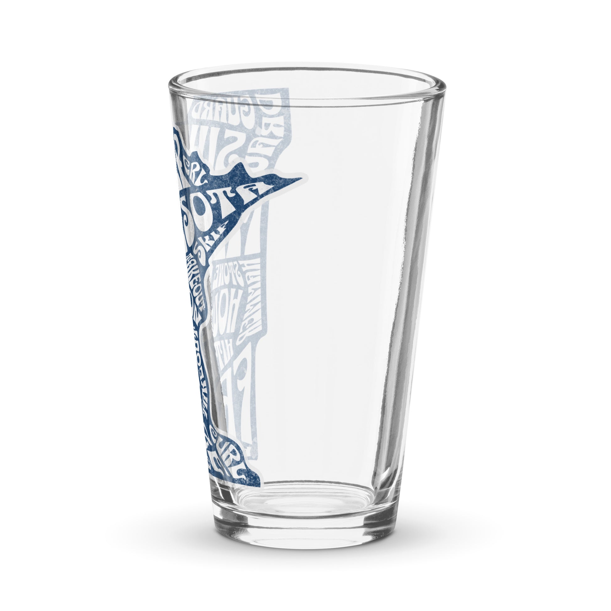 Angled view of a clear shaker pint glass featuring a blue Minnesota state outline with curling terms such as sweep, guard, button, freeze, and hog line, partially visible along the side of the glass. Curling-themed drinkware by CRL.